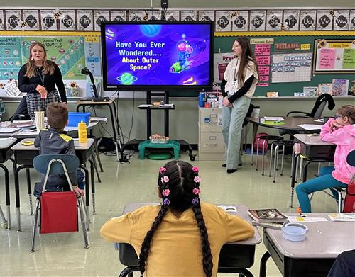student teachers talk to kids in classroom